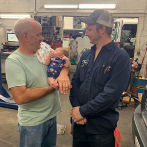two men with a cute baby